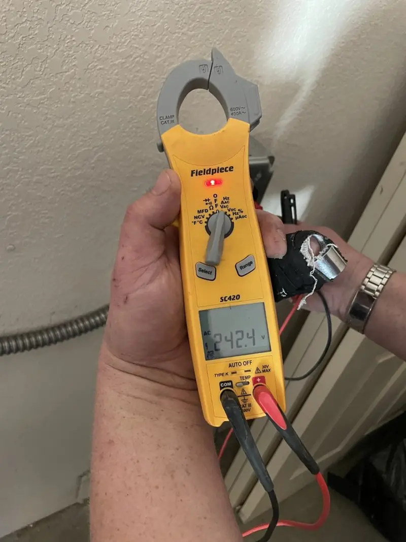 Voltage testing with clamp meter during Ceiling Fan Installation in Magee